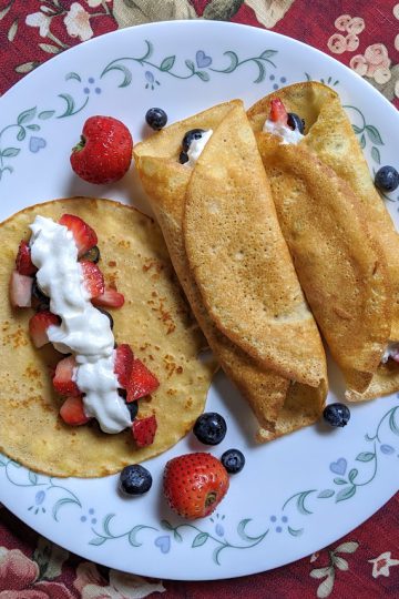 whole wheat crepes, served with berries and whipped cream