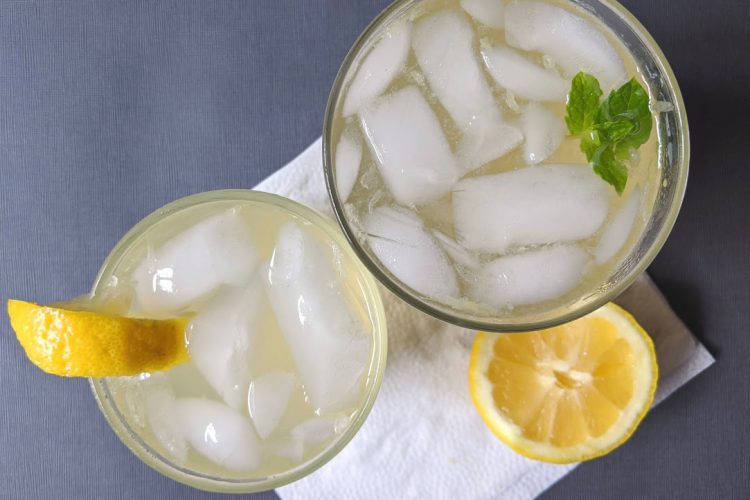 Shikanji glasses viewed from above, with lemon garnish