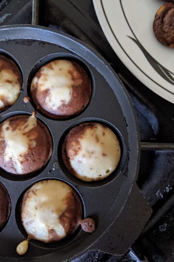 pancake bombs cooking in pan on stove