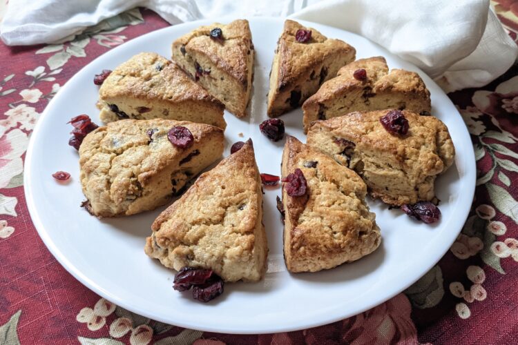 Eight cranberry scones on a plate, viewed from the side