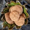 Pumpkin spice cookies in a green leaf bowl, top view