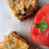 Cornbread Casserole on cutting board with red bell pepper