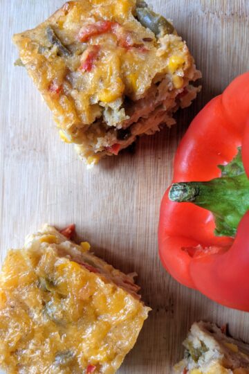 Cornbread Casserole on cutting board with red bell pepper