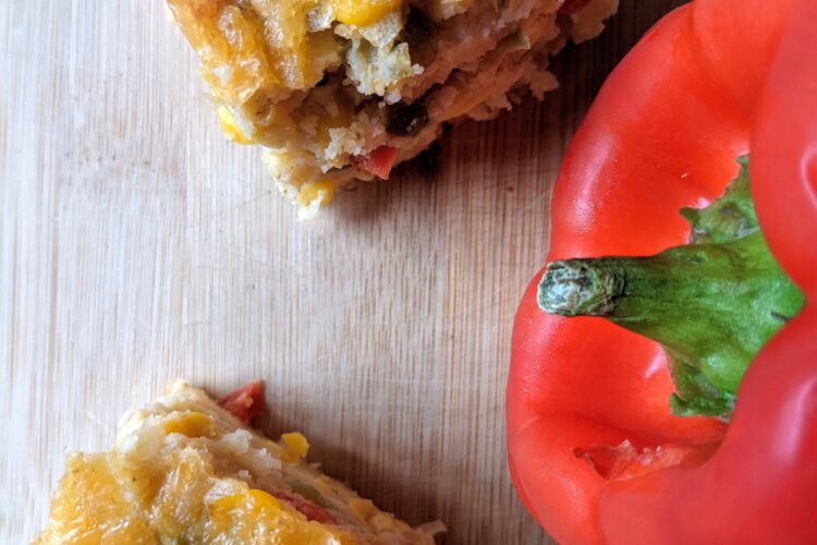 Cornbread Casserole on cutting board with red bell pepper