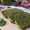 Spinach sandwich bread on cutting board, side view with loaf in background