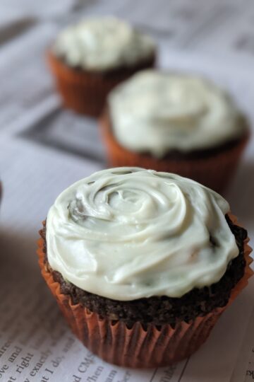 3 Matcha White Chocolate Cupcakes on newspaper