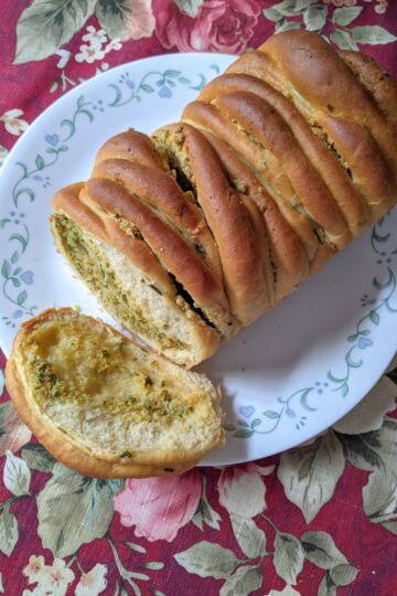 Rosemary Garlic Bread on plate with a slice