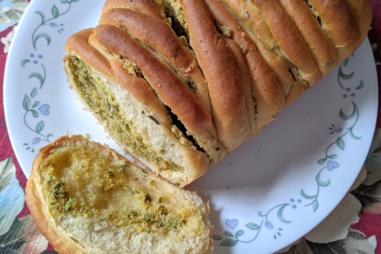 Rosemary Garlic Bread on plate with a slice