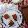 Molasses-Free Gingerbread Loaf Pieces on large plate with milk and pan