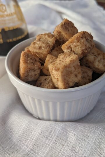 Crispy Baked Tofu in small bowl with soy sauce in background