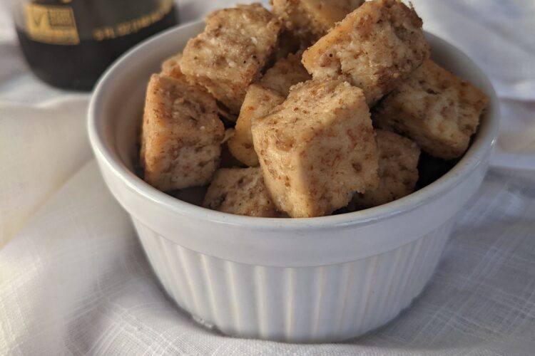 Crispy Baked Tofu in small bowl with soy sauce in background