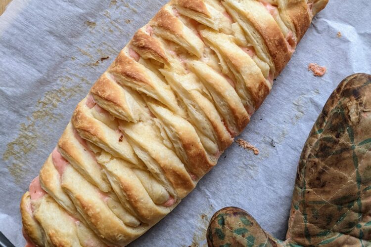 Rose danish braid on tray with oven mitt top view