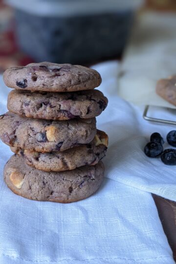 Vegan blueberry cardamom cookies stack on white cloth