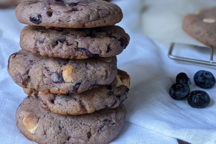 Vegan blueberry cardamom cookies stack on white cloth