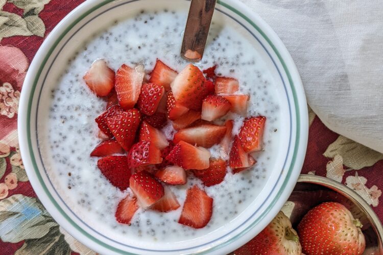 3-ingredient Chia Pudding top view with whole strawberries on side