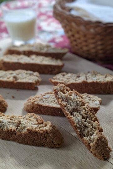 Banana Almond Biscotti with milk glass and basket in background
