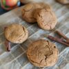 Stuffed pumpkin peanut butter cookies on a cooling rack with a can of pumpkin puree